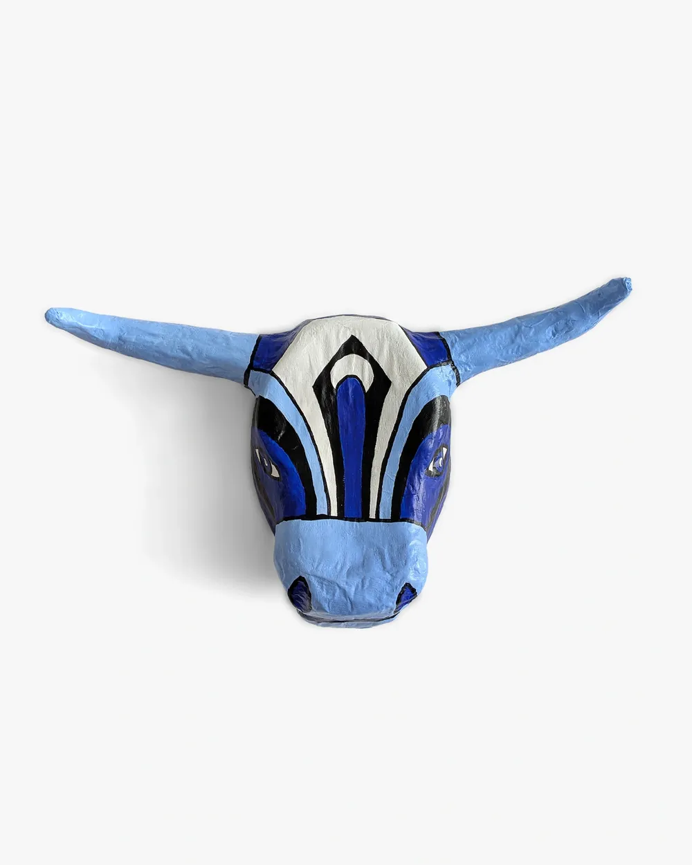 Toro Azul, papier-mâché bull's head painted in light blue, cobalt, black and white, seen frontally